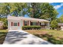 Exterior view with a long driveway leading to a cozy single-story home at 1907 Clarke Ln, Decatur, GA 30035