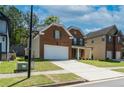 Well-maintained home featuring brick facade, attached two-car garage, and a neatly landscaped lawn at 351 Chandler Bluff Ct, Grayson, GA 30017