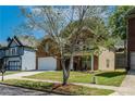 Charming home with a brick facade, an attached garage, and a lush tree in the front yard at 351 Chandler Bluff Ct, Grayson, GA 30017