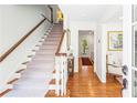 Bright foyer showcasing hardwood floors and a carpeted staircase leading to the upper level at 3562 Sunderland Ne Cir, Atlanta, GA 30319
