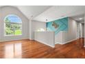 Bright landing boasts hardwood floors and a large window at 3927 Villager Way, Rex, GA 30273