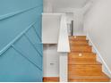 Staircase features hardwood steps and a decorative accent wall at 3927 Villager Way, Rex, GA 30273