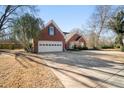 Attractive brick home with an attached two-car garage and long driveway at 7430 Valley Landing Ct, Cumming, GA 30041