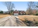 Beautiful brick home with a spacious driveway and a well-manicured lawn at 7430 Valley Landing Ct, Cumming, GA 30041