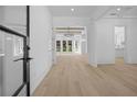 Bright foyer showcasing hardwood floors, a modern chandelier, and an open floor plan at 819 Loridans Ne Dr, Atlanta, GA 30342