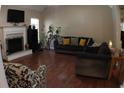 Spacious living room with hardwood floors and a cozy fireplace, perfect for relaxing and entertaining guests at 545 Chaseridge Dr, Mcdonough, GA 30253