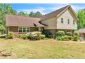Charming home featuring brick accents, a manicured lawn, and lush landscaping at 9082 Chestnut Lake Dr, Jonesboro, GA 30236