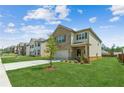 Two-story home with brick and siding, attached garage, and a green lawn on a sunny day at 814 Lakehaven Ln, Loganville, GA 30052