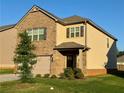 Charming two-story home features brick and siding exterior with well-maintained lawn at 814 Lakehaven Ln, Loganville, GA 30052