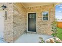 Close-up of the front entrance featuring a brick facade and a stylish black door at 814 Lakehaven Ln, Loganville, GA 30052