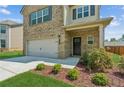 Inviting two-story home features brick accents, a garage, and manicured landscaping at 814 Lakehaven Ln, Loganville, GA 30052