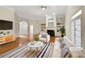Bright living room with hardwood floors, fireplace, and built-in shelving at 105 Laurel Ridge Ct, Fayetteville, GA 30215