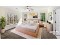 Staged primary bedroom featuring three windows and neutral decor at 105 Laurel Ridge Ct, Fayetteville, GA 30215