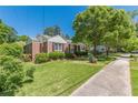 Well-maintained home with lush lawn, sidewalk, and mature shade tree at 1325 East Forrest Ave, East Point, GA 30344