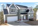 Two-story home featuring neutral siding, a dark roof, white trim, and an attached two-car garage at 3180 Tackett Rd, Douglasville, GA 30135