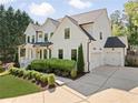 Beautiful two-story home with white siding, a well-manicured lawn, a two-car garage, and a concrete driveway at 1395 Oconee Ne Pass, Brookhaven, GA 30319