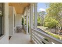 Inviting front porch featuring white painted brick, a wood ceiling, classic columns, and stylish outdoor furniture at 1395 Oconee Ne Pass, Brookhaven, GA 30319