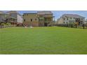 Expansive backyard with lush lawn, a charming fence, and an inviting patio seating area at 326 Carmichael Cir, Canton, GA 30115