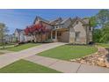 Beautiful two-story home features manicured lawn, brick accents, and charming front porch at 326 Carmichael Cir, Canton, GA 30115