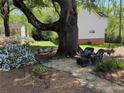A relaxing backyard seating area, landscaped with a large tree swing and a bench at 510 Birch Ridge Ct, Roswell, GA 30076