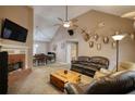 Spacious living room with a brick fireplace, vaulted ceiling, and ample seating at 70 Summer Walk Dr, Covington, GA 30016
