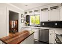 Modern kitchen features white cabinets, stainless steel appliances, and a window overlooking the backyard at 4727 Emily Sw Dr, Lilburn, GA 30047