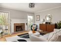 Bright and airy living room with a brick fireplace, hardwood floors, and stylish decor at 4727 Emily Sw Dr, Lilburn, GA 30047