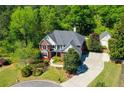 Beautifully landscaped property with mature trees and a long driveway on a large lot at 844 Nob Ridge Dr, Marietta, GA 30064