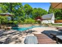 Lounge by the pool with stone waterfall feature, surrounded by lush greenery and seating areas at 844 Nob Ridge Dr, Marietta, GA 30064