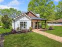 Charming exterior view of this beautifully landscaped home featuring a cozy front porch at 1809 Cassville Nw Rd, Cartersville, GA 30121