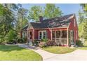 Quaint red home featuring a screened-in porch, landscaped yard, and inviting curb appeal at 2733 Winburn Ter, East Point, GA 30344