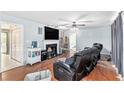 Spacious living room featuring a fireplace, hardwood floors, and a ceiling fan at 2958 Paul Harris Rd, Dallas, GA 30157