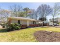 View of the home with a well-maintained lawn and mature trees at 43 Lott Se Ave, Marietta, GA 30067