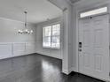 Elegant entryway featuring hardwood floors, decorative molding, and a view into the dining area at 5749 Creek Indian Dr, Sugar Hill, GA 30518