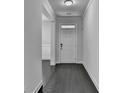 Bright hallway with hardwood floors and neutral paint, leading to various rooms in the house at 5749 Creek Indian Dr, Sugar Hill, GA 30518