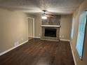 Inviting living room features a stone fireplace and hardwood floors providing a cozy space to relax at 1106 Hardy Cir, Dallas, GA 30157