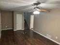 A well lit living room features hardwood floors and a ceiling fan at 1106 Hardy Cir, Dallas, GA 30157