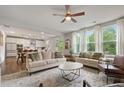 Bright and airy living room with large windows, comfortable seating, and an open layout to the kitchen at 13 Oakside Nw Ct, Cartersville, GA 30121