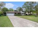 Spacious driveway leading to a two-story home, surrounded by greenery, and showcasing its curb appeal at 1608 Drakes Dr, Jonesboro, GA 30236