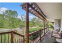 Relaxing porch view with comfortable seating, wrought iron railings, and a pergola at 1608 Drakes Dr, Jonesboro, GA 30236