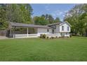 Charming white brick home with well-manicured lawn and covered carport at 3935 Manor House Dr, Marietta, GA 30062
