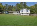 Charming white brick home with well-manicured lawn and covered carport at 3935 Manor House Dr, Marietta, GA 30062