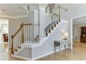 Elegant staircase with white railings, hardwood steps, and views into the home's interior at 1315 Chattahoochee Run Dr, Suwanee, GA 30024