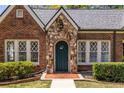 Attractive brick home featuring a stone entryway and manicured landscaping at 1900 Ridgewood Ne Dr, Atlanta, GA 30307