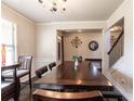 Spacious dining room with hardwood floors, decorative lighting, and easy access to other rooms at 375 Madison Grace Ave, Mcdonough, GA 30252