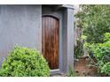Close-up of a beautiful wood front door framed by lush green landscaping at 588 Bismark Ne Rd, Atlanta, GA 30324