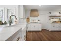 Charming kitchen with white cabinets, hardwood floors, and stone countertops at 1050 Willeo Ct, Marietta, GA 30068