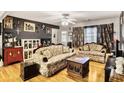 Spacious living room with hardwood floors, eclectic decor, and vintage furniture at 1400 Hidden Circle Dr, Sugar Hill, GA 30518
