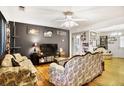 Comfortable living room with hardwood floors, ceiling fan, and vintage-style decor at 1400 Hidden Circle Dr, Sugar Hill, GA 30518