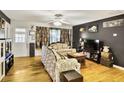 Inviting living room with hardwood floors, ceiling fan, and eclectic decor at 1400 Hidden Circle Dr, Sugar Hill, GA 30518